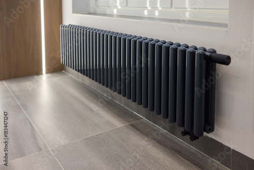 Wallpaper Mural Subtle natural light highlights terrazzo textured flooring and radiator, Industrial inspired space showcasing functional heating element beneath window in neutral tones Torontodigital.ca