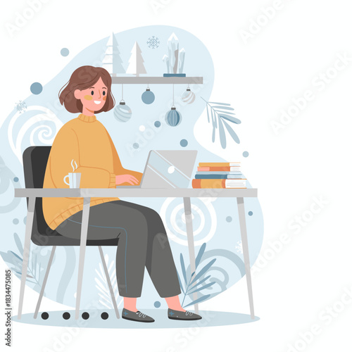 Happy woman works remotely on laptop at a cozy winter desk decorated with holiday ornaments