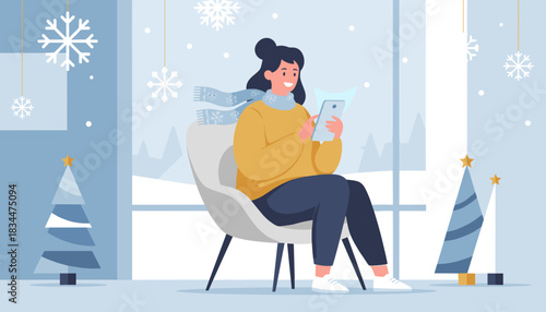 Smiling woman using tablet indoors during winter holidays surrounded by snowflakes and Christmas decor