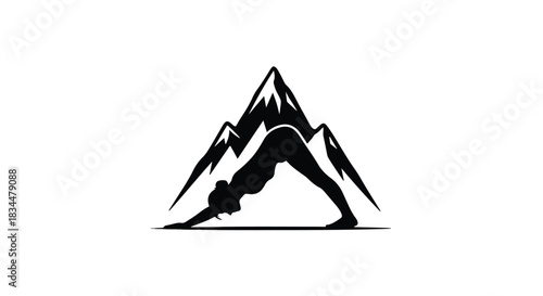 Silhouette of a woman in downward dog yoga pose against a mountain backdrop