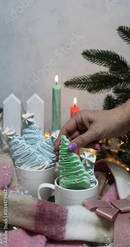 Woman lighting christmas tree meringue candle stick