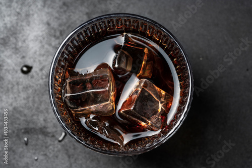 Whiskey with Ice Cubes in Glass – Top View on Dark Background