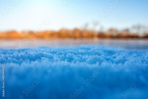 Landscape with shiny crystals of cold transparent blue hoarfrost lie in a win...