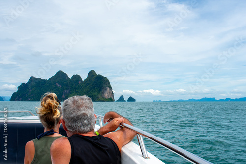 Tableau sur toile Happy couple sitting on a boat together on holiday in Phuket, Thailand