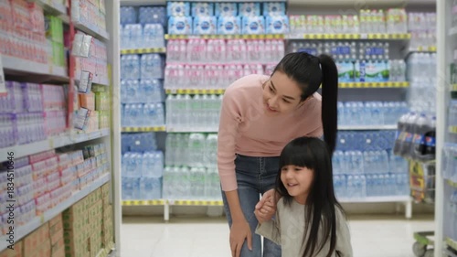 Shopping concepts of 4k Resolution. An Asian mother and her daughter are selecting beverages in the supermarket.