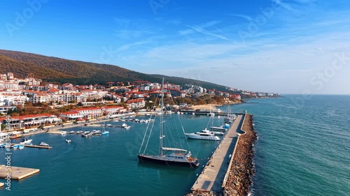 Wallpaper Mural Flight over the berth with modern yachts standing by. Numerous hotels are on the slopes of the mountains at backdrop. Nessebar, Bulgaria. Torontodigital.ca