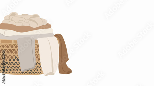 Woven laundry basket filled with clothes and various textiles. Laundry basket holds neutral toned garments and fabrics, representing daily household chores.