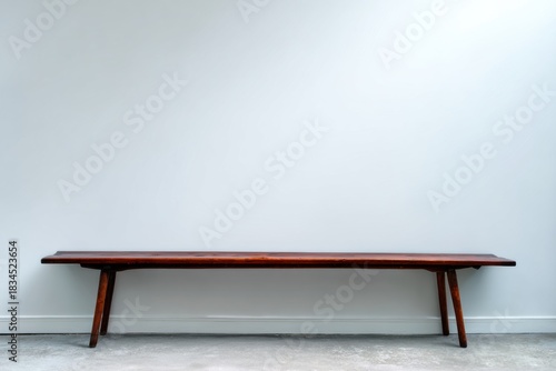 Minimalist Wooden Bench Against White Wall
