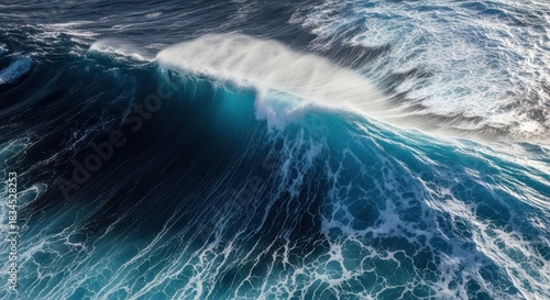 Fototapeta Naklejka Na Ścianę i Meble -  Powerful ocean wave cresting with foamy white spray and deep blue water