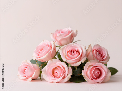 Pink rose bouquet against soft pink background, elegant romantic floral arrangement with gentle pastel tones
