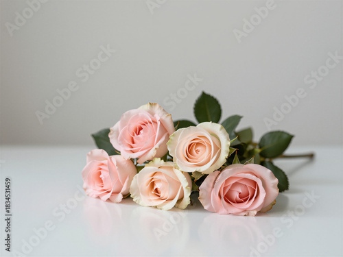 Soft pink rose bouquet on light surface, elegant romantic floral arrangement with gentle pastel tones