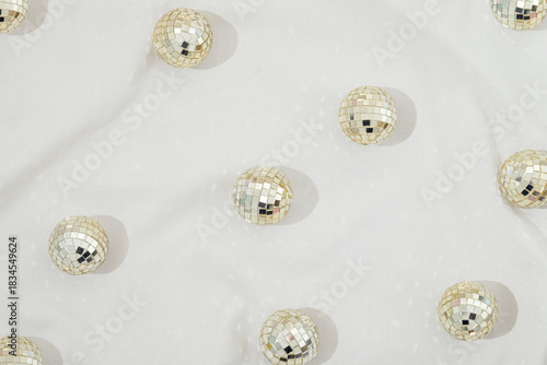 Pattern made of disco balls with  sparkle on a white background.  Bright retro aesthetic party concept. Christmas and New Year wallpaper.	