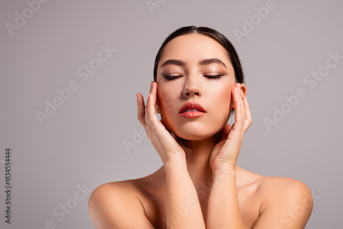 Portrait of a stunning young woman with flawless makeup and styled hair, exuding elegance and beauty