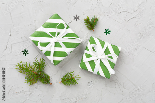 Striped Christmas gift boxes on concrete background, top view