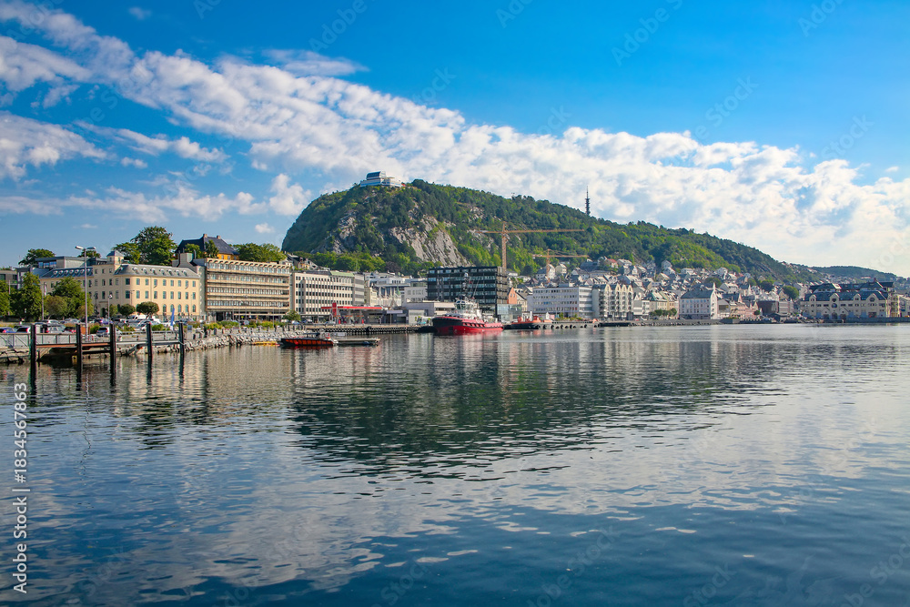 Naklejka premium View of the town of Alesund from the water including the viewpoint Aksla, Art Nouveau buildings and boats. Beautiful scenic down town harbour view. Alesund, Norway.