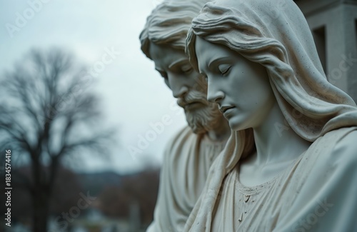Marble pieta statue of Jesus and Mary in cemetery. Stone sculpture shows grieving mother with her son. Religious art, tradition, mourning, spiritual symbol, solemnity.