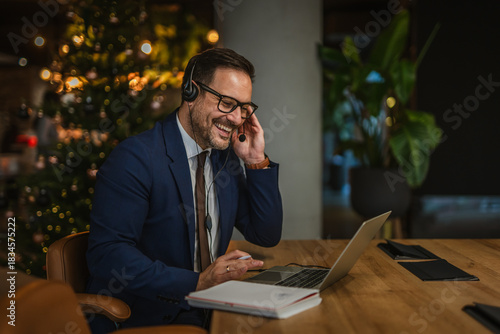 Businessman teleworking having a cheerful video call during christmas