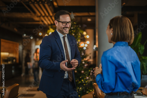 Business colleagues networking and discussing work at office christmas party