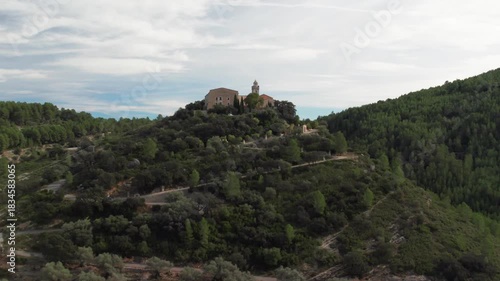 Aerial footage of the Hermitage of Hermitage of Our Lady of the Angels surrounded by a dense green olive trees fields