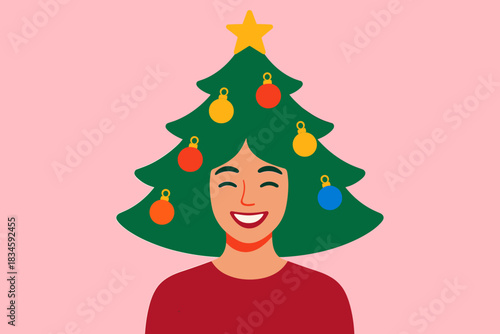 A joyful woman wearing a green wig shaped like a Christmas tree poses for a New Year's themed photo shoot against a pink backdrop, surrounded by a festive atmosphere and colorful baubles adorning her