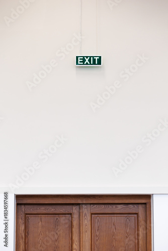 Emergency exit sign above the door. Clean and simple emergency exit sign on neutral background. Copy space.