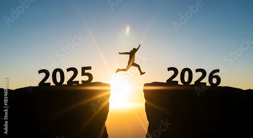 Visualize your business goals and future success with this inspiring image of a person jumping from 2025 to 2026 during a vibrant sunrise scene.