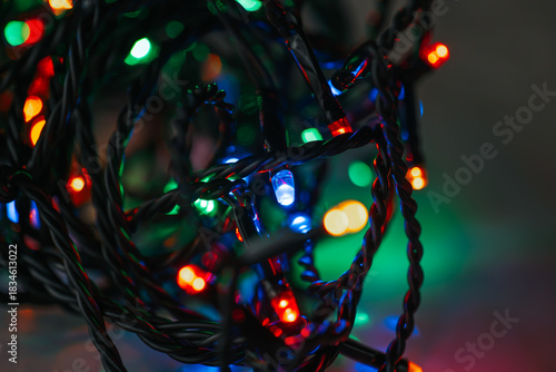 Garland lights and multicolored bokeh close-up.Close-Up of Christmas Lights with Bokeh Effect.Tangled String of Christmas Lights