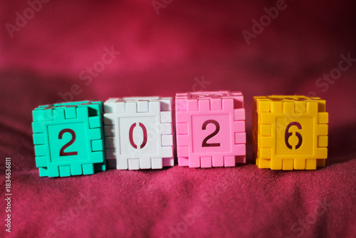 Colorful plastic number blocks arranged to form “2026,” creating a playful and bright New Year theme. Perfect for holiday greetings, education materials, and festive promotional designs.