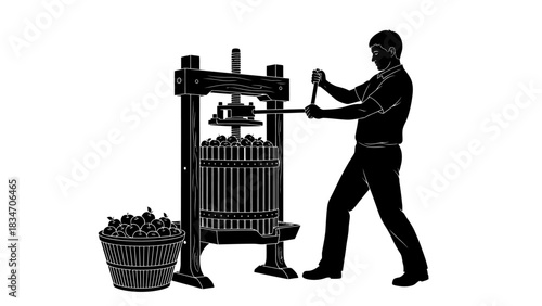 Traditional winemaking process Man operating a wine press with grapes in a basket