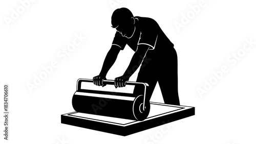 Artist applying ink to a printing plate with a roller for a graphic art creation