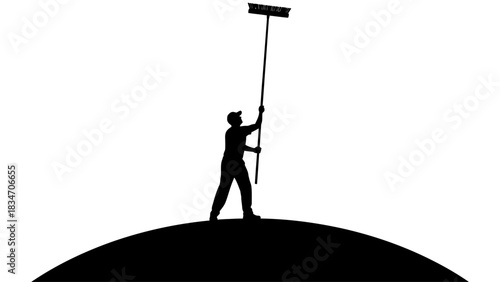 Silhouette of a person on a hill cleaning the sky with a long broom