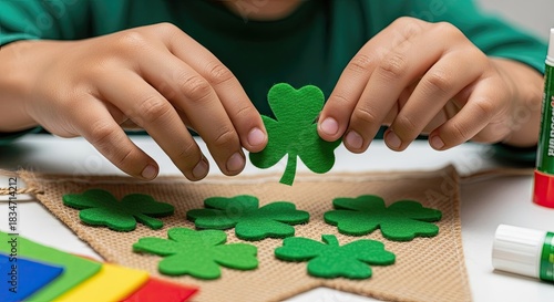 Child crafting green shamrock for St. Patrick's Day. St. Patrick's creative holiday decor