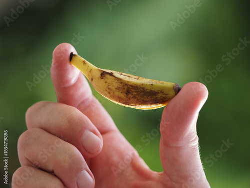 Small tiny size of banana in hand.