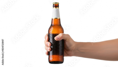 Hand holding a cold amber beer bottle with a black label isolated on black