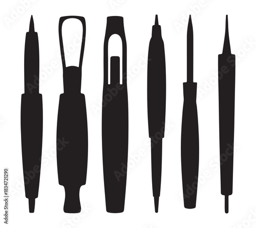  Collection of silhouetted tattoo machine needles and cartridges on a white background