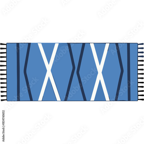 Flat lay of a blue rug with a geometric pattern featuring white and dark blue diamond shapes and fringe edges on a black background