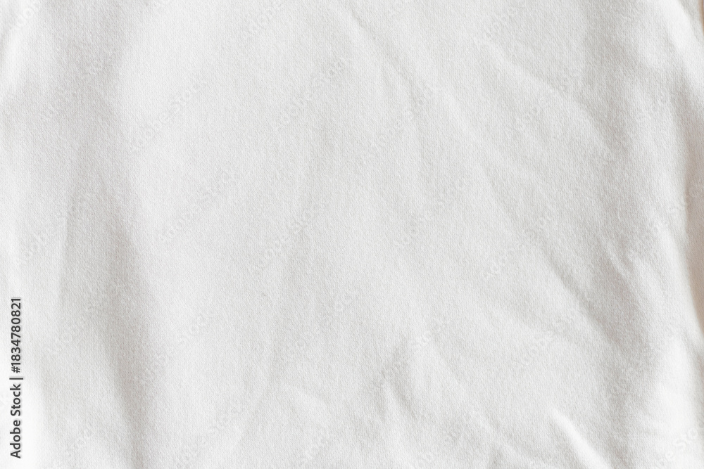 Naklejka premium Close-up of wrinkled white cotton fabric texture. Trendy color of 2026 year