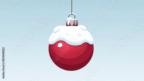 A single festive red christmas ornament covered in soft white snow hangs suspended against a clear pale blue winter sky background