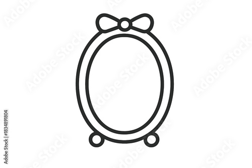 Elegant antique style oval table mirror standing on a surface with a decorative ribbon bow detail