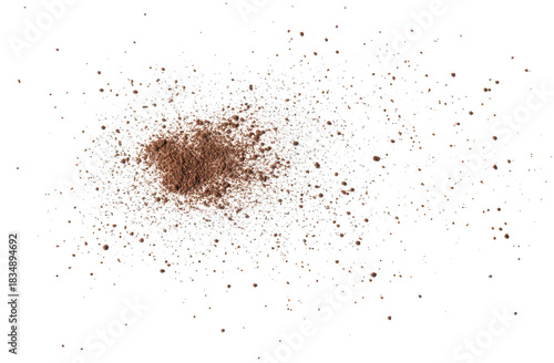A scattering of fine brown powder on a white background. resembling cocoa or coffee grounds. creating a visually appealing texture ideal for culinary and design applications