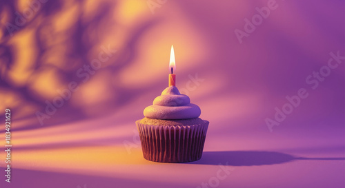 Minimalist birthday cupcake with single lit candle on purple and yellow gradient background, warm celebration concept, copy space