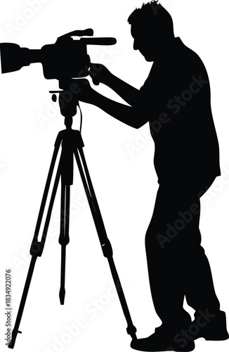a silhouette of a cameraman operating professional video equipment on a tripod