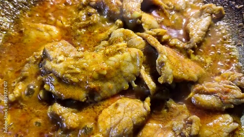 Frying chopped pork with chili paste in pan, indoor Chiangmai Thailand.