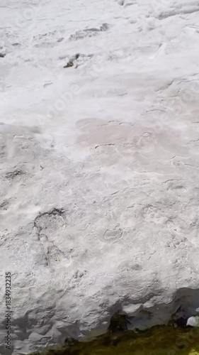 Pamukkale, the cotton castle and cotton hill, white travertine natural hot spring and ancient Roman Greek bath house at Hierapolis ruins site, Turkiye