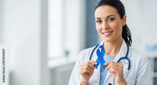 Blue November awareness ribbon shown by female doctor in support. Blue November campaign includes support for prostate cancer awareness,