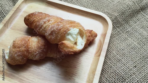 cream horn bread pastries on wooden board