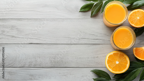 Fresh orange juice glass and sliced orange on wooden table, bright refreshing mood