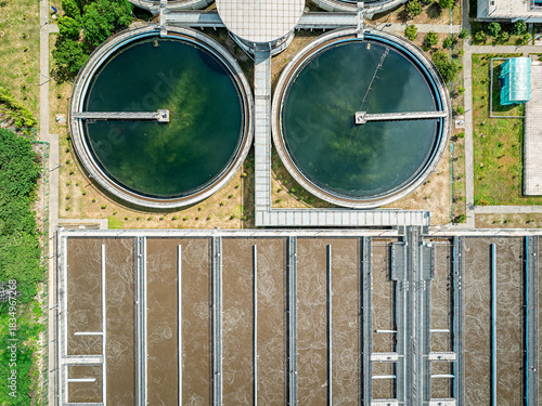 Aerial top down view of sewage water treatment plant with biological cleaning tanks.
