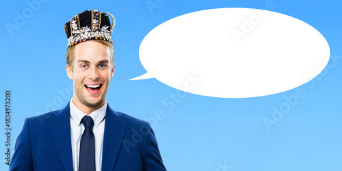 I am business king! Portrait of happy smile formal businessman man in crown isolate sky blue background with white empty mockup speech bubble blank free text space. Leadership, success deal ad concept