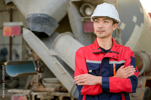 An engineer standing confidently in front of a concrete mixer truck, representing safety, professionalism, and reliable concrete plant operations.